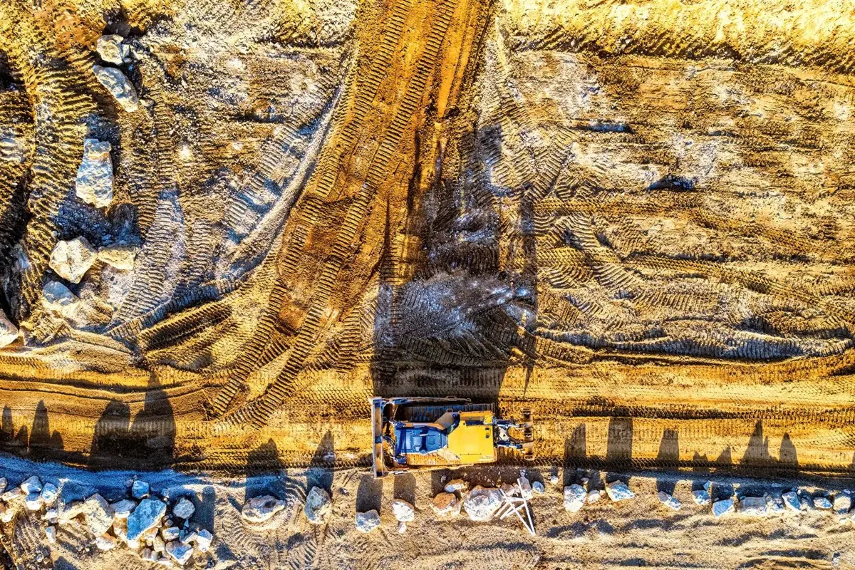 Aerial view of earthmoving machinery and graded soil