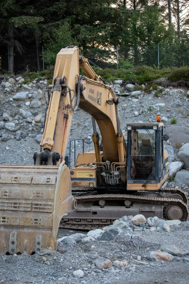 Tracked excavator on rocky ground